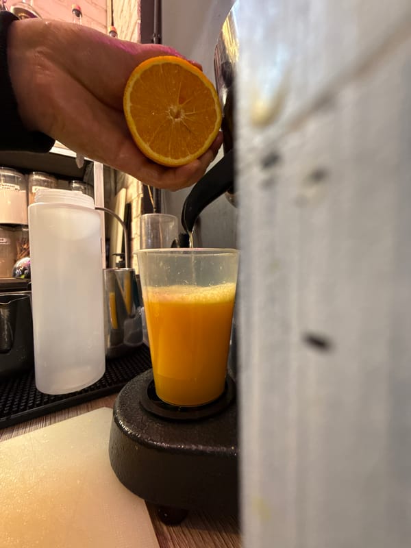 Fresh orange juice being squeezed into a cup in Moscow