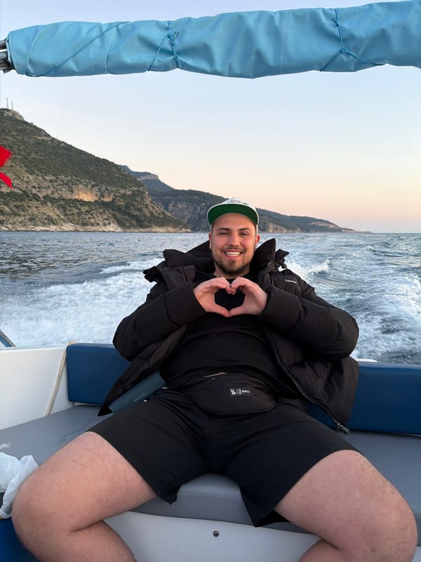 Man Makes Heart Gesture on Boat During Turkish Coast Sunset
