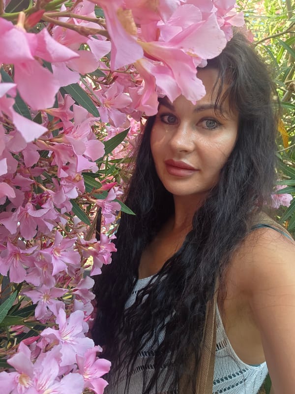 Portrait session among pink oleanders in summer Sochi