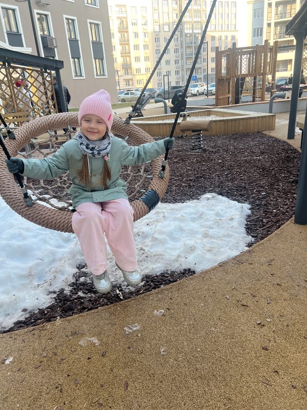 Girl enjoys playground swing in snowy Russian town