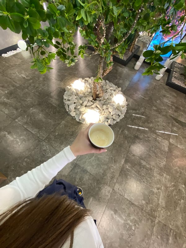 Woman takes morning coffee selfies in Votkinsk interior