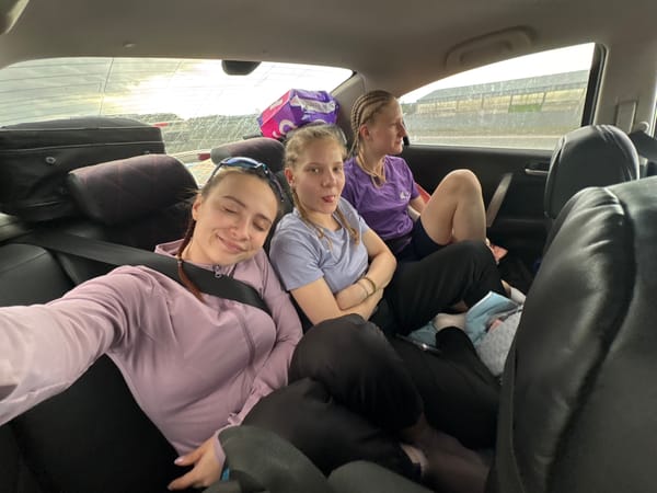 Young women relax in car backseat in Russia
