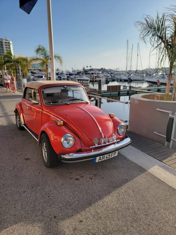 Quarteira marina at golden hour: yachts, sports cars, and promenade life