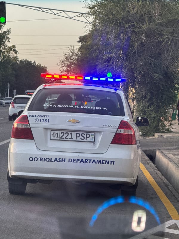 Patrol car spotted at Tashkent intersection during evening traffic