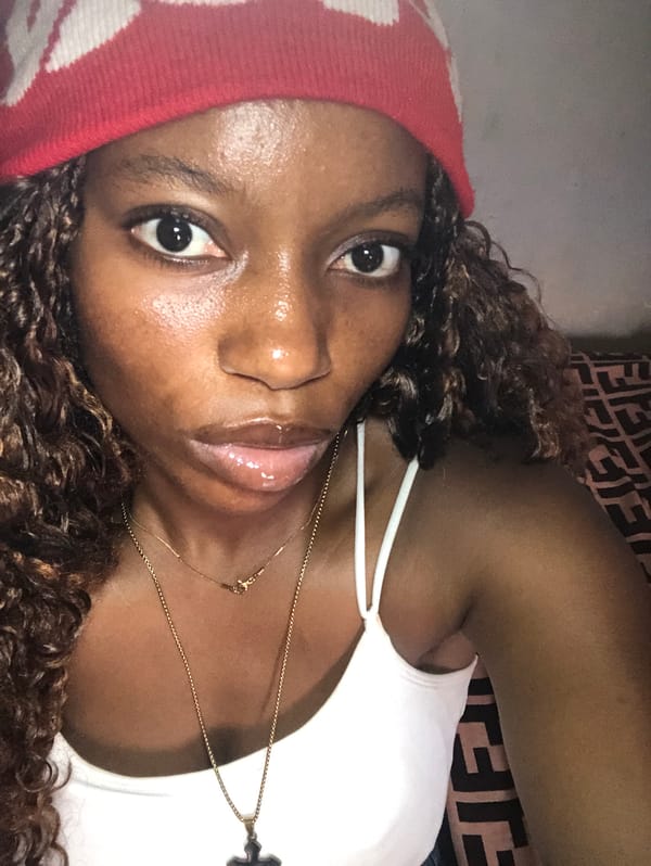 Woman in red hat rests in Nigeria