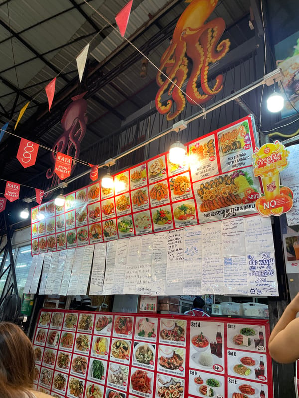 Food vendors serve customers at Kata Night Market, Thailand