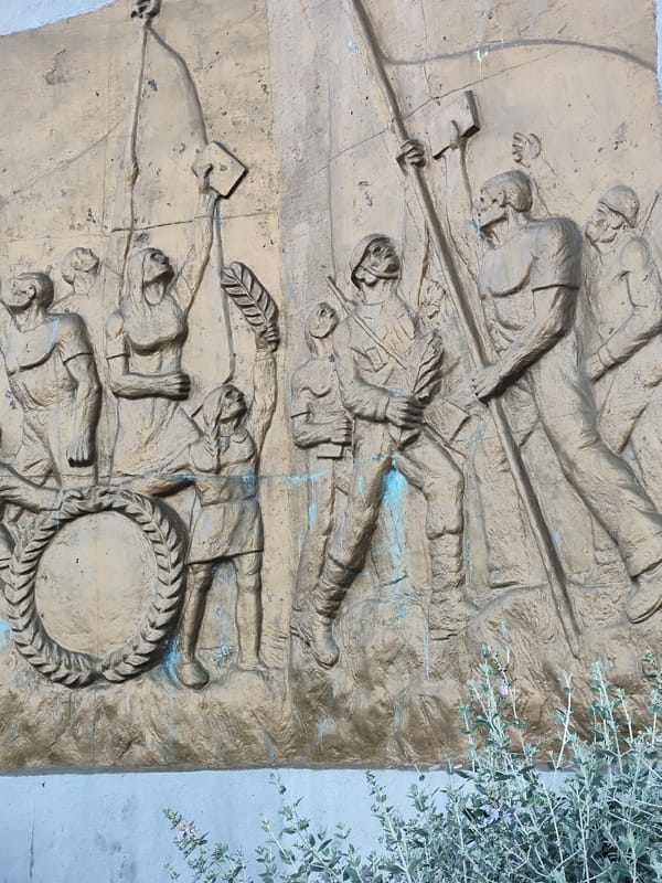 Witnesses document Atatürk monument with wreath in urban setting