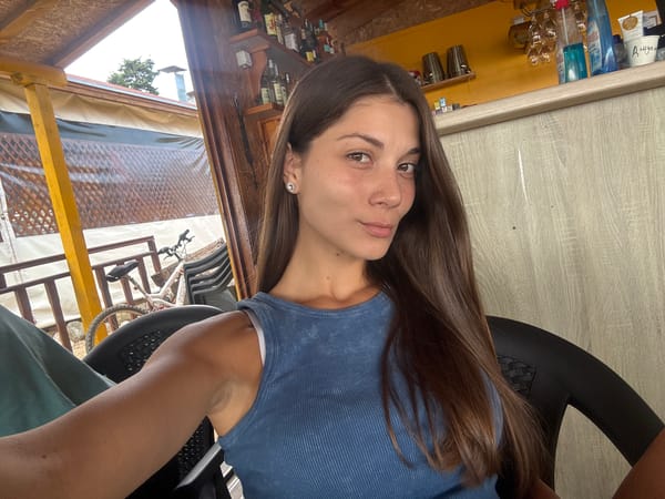 Selfie session at a rustic Sozopol café, fruit plate on the side