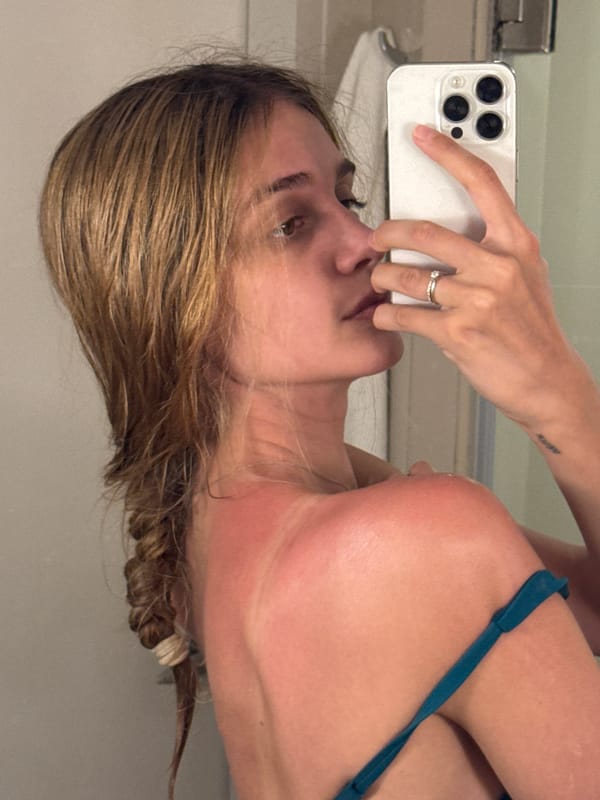 Woman enjoys yellow drink at Patong beach