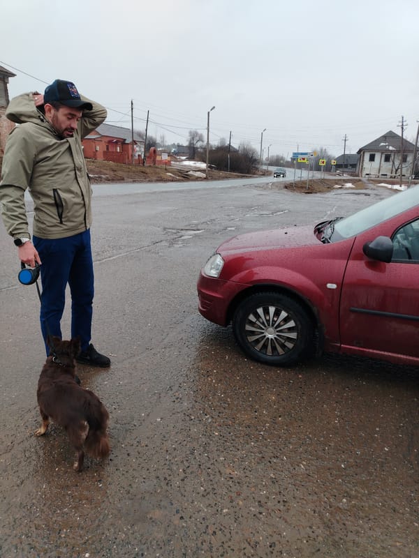 Man with dog spotted on wet street in Russia
