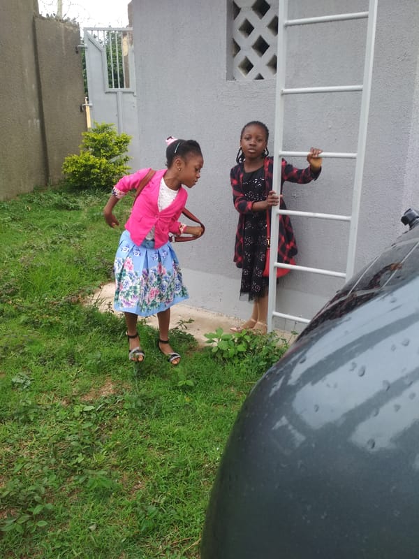 Community gathering observed outside building in Jos, Nigeria