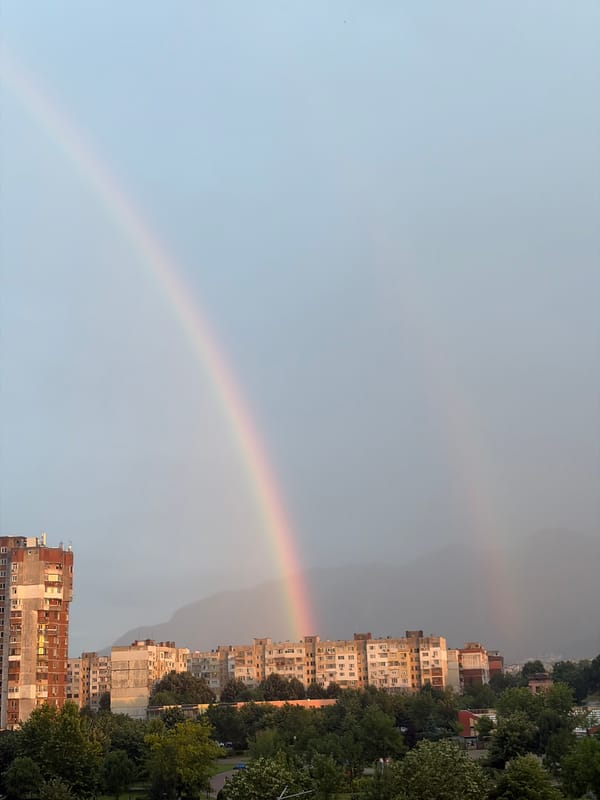 Rainbow over Vratsa's Soviet-era skyline, July evening