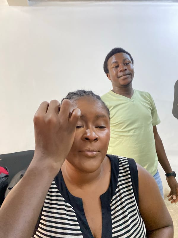 Woman receives makeup application in Gura Top, Nigeria