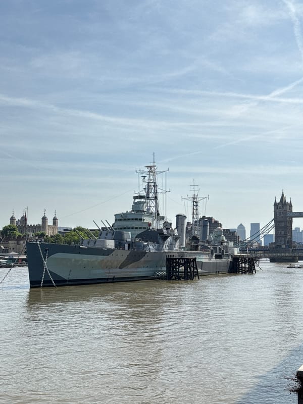 Tourist captures iconic London landmarks during Thames riverside walk