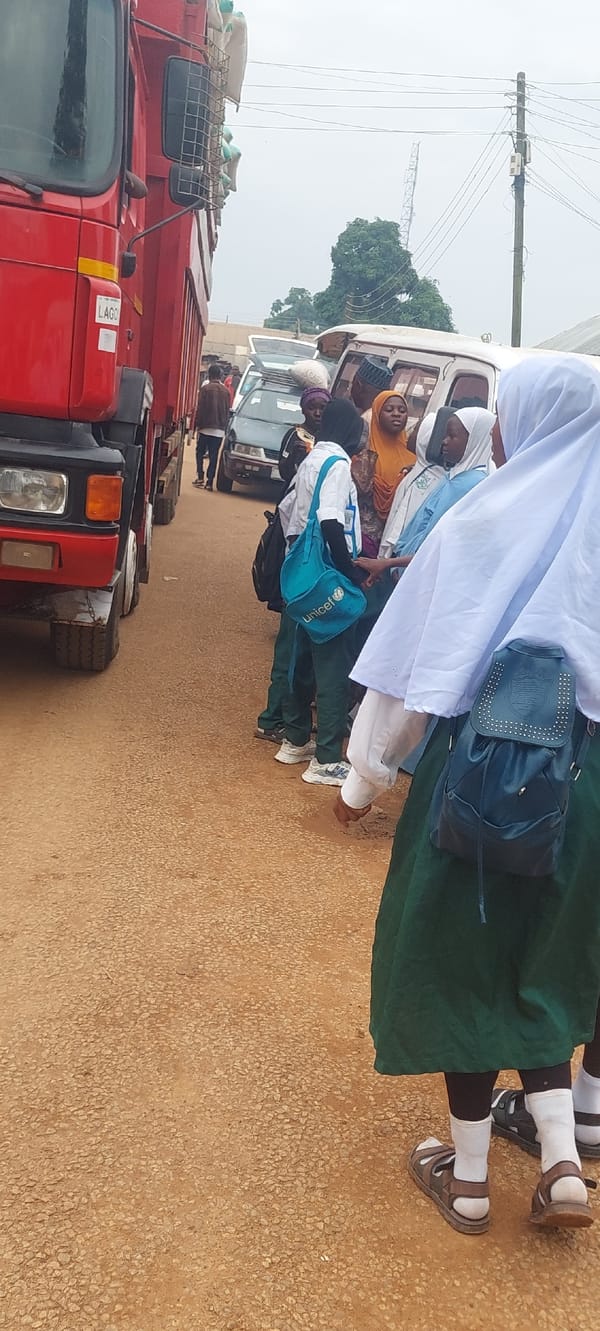 Market day activity around grain truck and street vendors