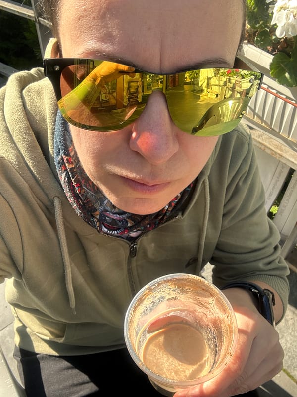 Person enjoys morning beverage outdoors in sunny Sofia