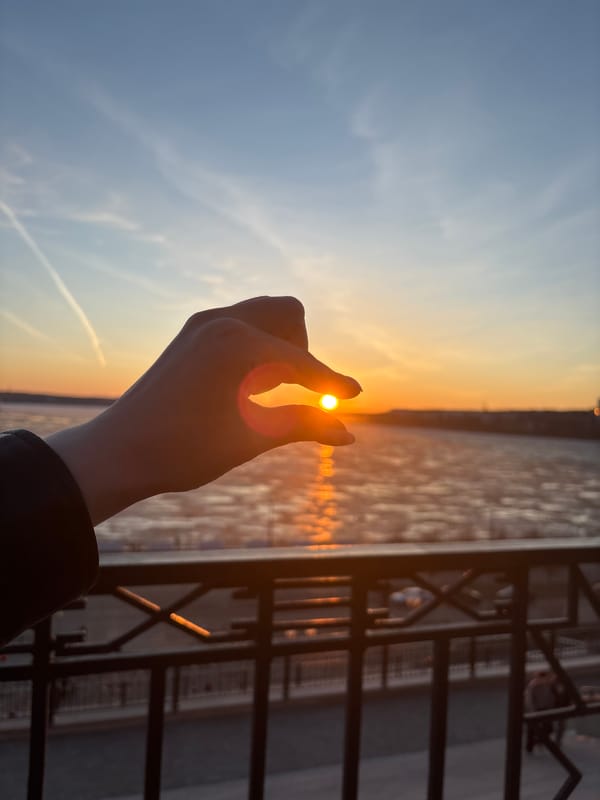 Woman takes sunset selfies along Izhevsk waterfront embankment