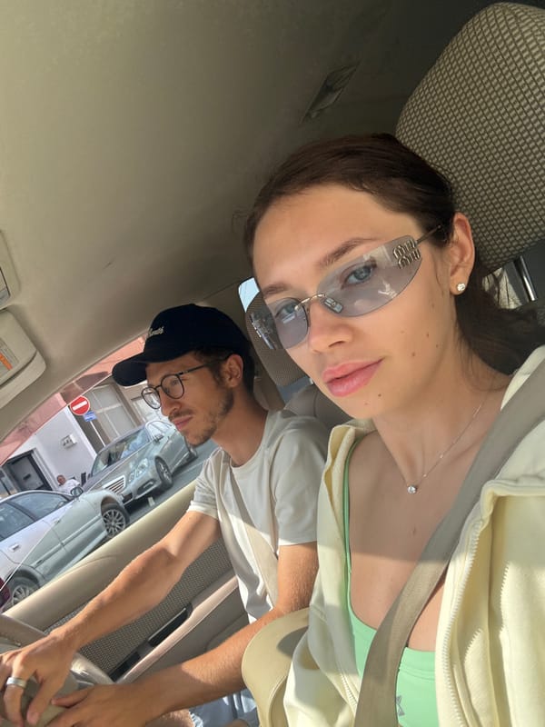 Two people photographed in car during sunny day in Larnaca