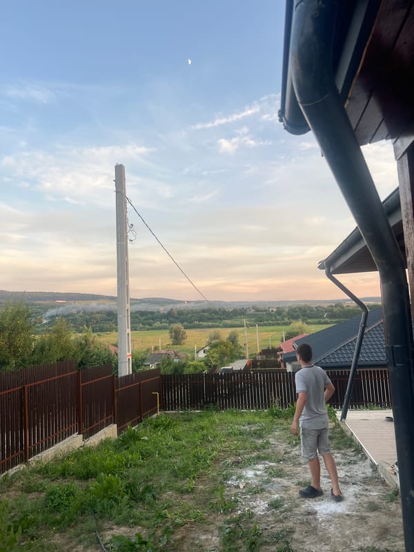 Rural Bârnova at golden hour: fences, fields, and wildflowers