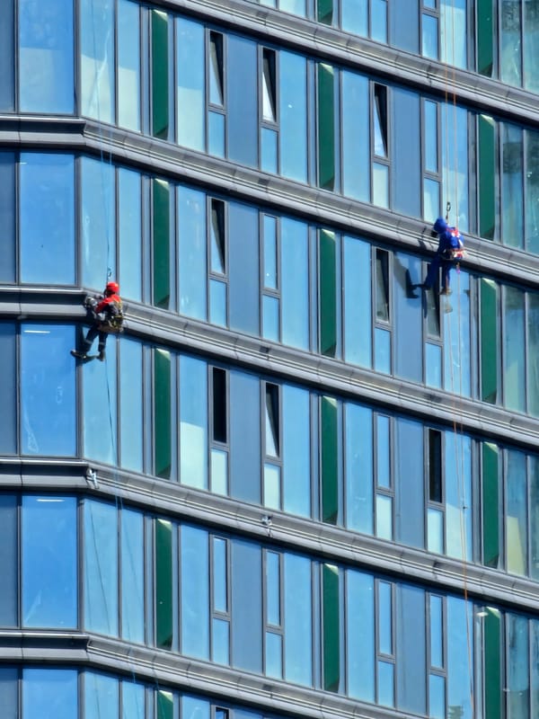 Window cleaners work Moscow skyscrapers during midday operations