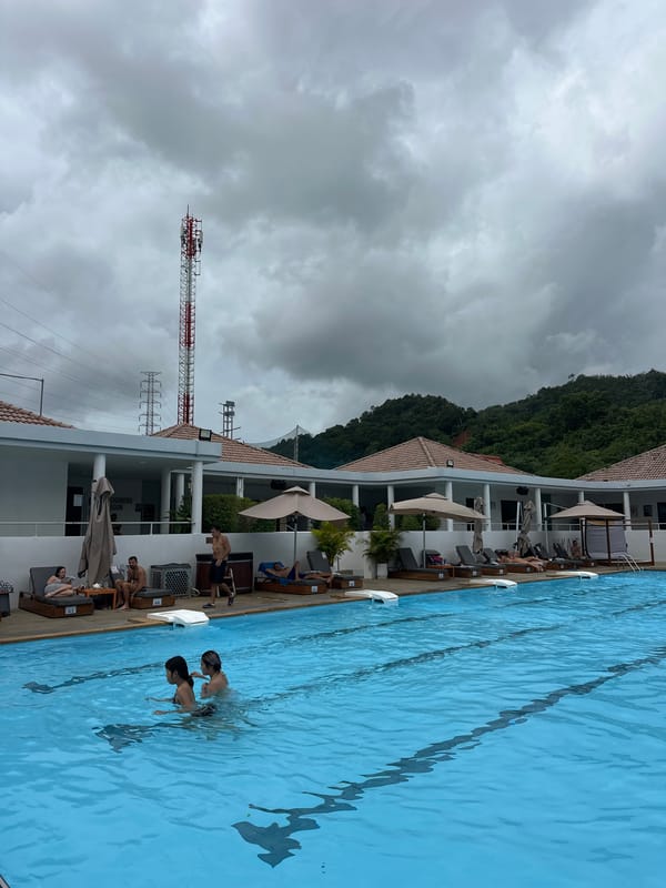 Poolside afternoon at a Kathu resort with DJ and overcast skies