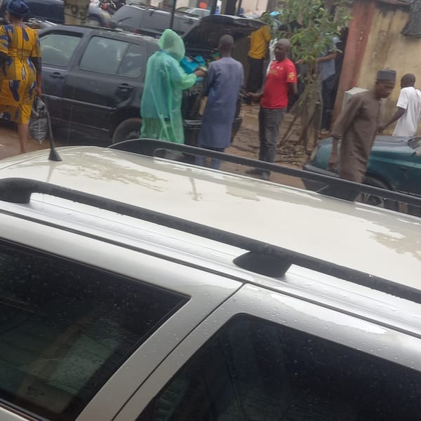 Daily street life documented across Nigerian towns during rain
