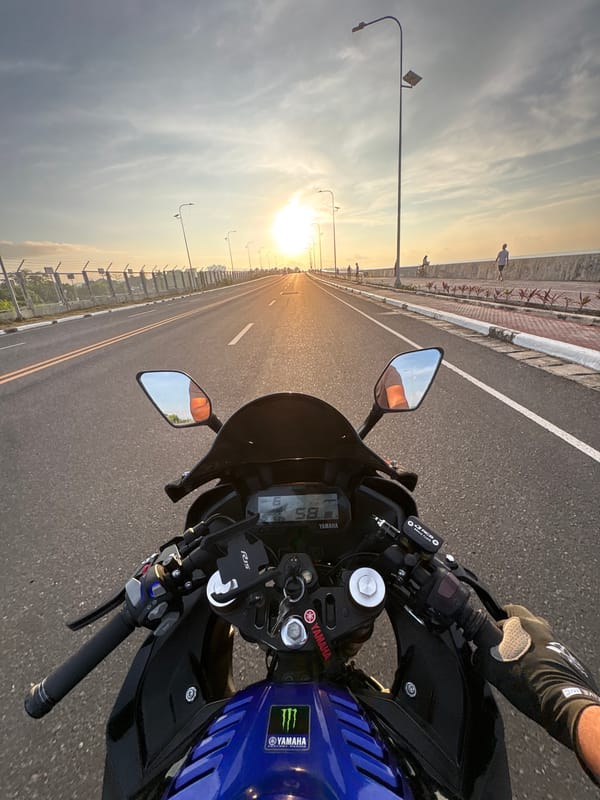 Motorcyclist rides Yamaha on Davao City highway at sunset