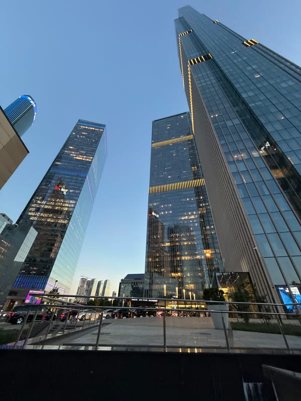 Twilight skyline photographed in Khimki, Russia shows three glass skyscrapers
