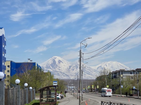 Urban witnesses capture volcanic mountain cityscape under clear skies