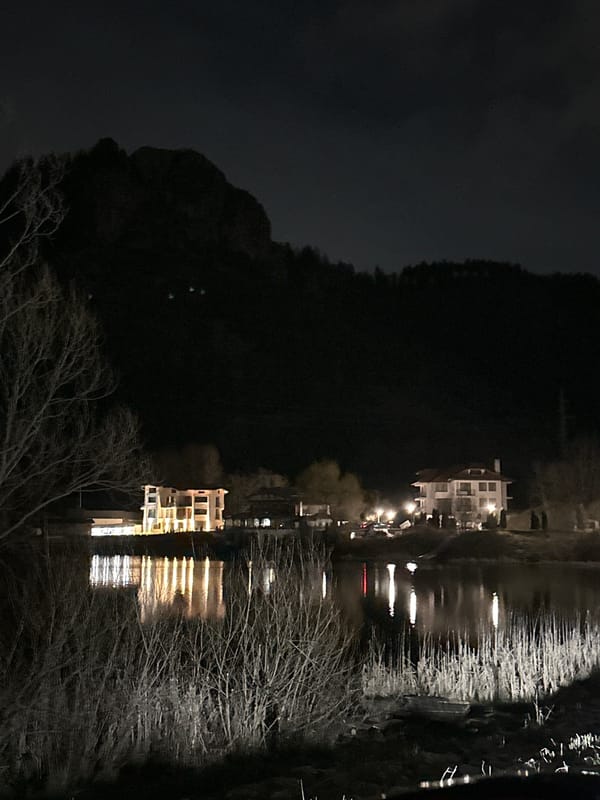 Evening lights reflect on water in Smolyan, Bulgaria