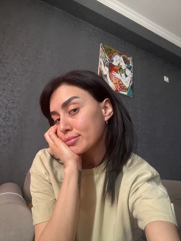 Woman poses for photos on couch in Tbilisi home