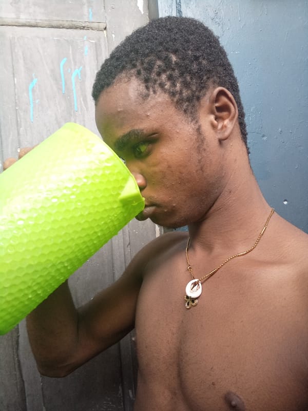 Young man takes playful kitchen selfies in Owerri, Nigeria