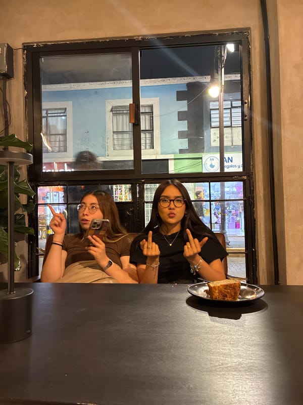Two women pose with middle fingers in San Andrés Cholula