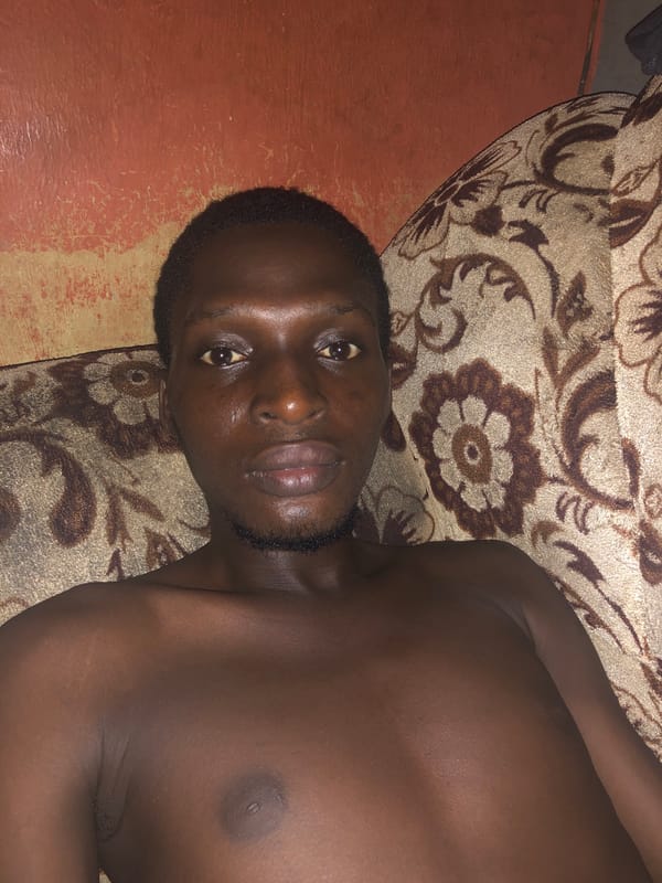 Man relaxes on couch with phone during evening hours