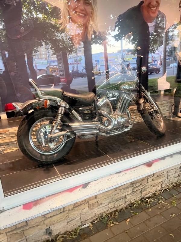 Storefront Yamaha display and sidewalk life in Voronezh