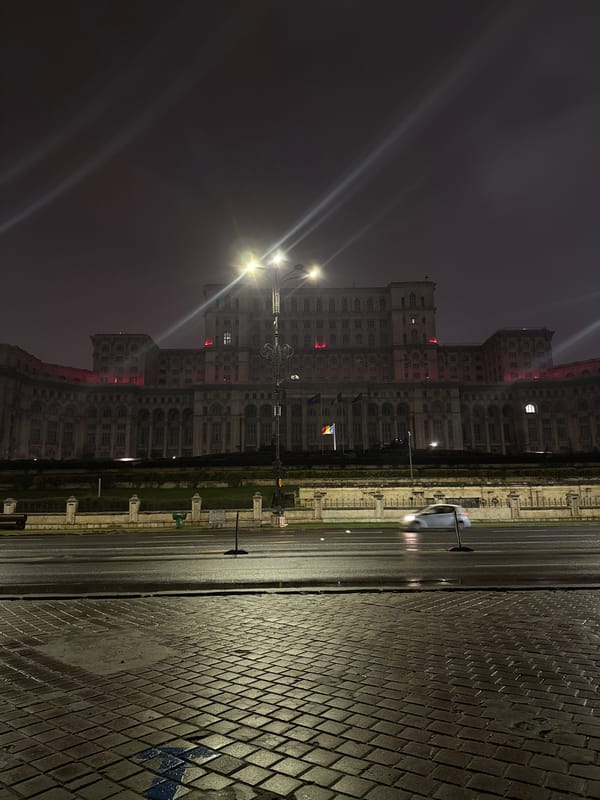 Palace of Parliament illuminated at night in Bucharest