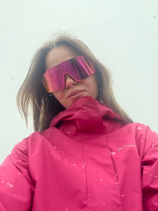 Skier takes selfie in pink gear amid snowfall in Kliuchi