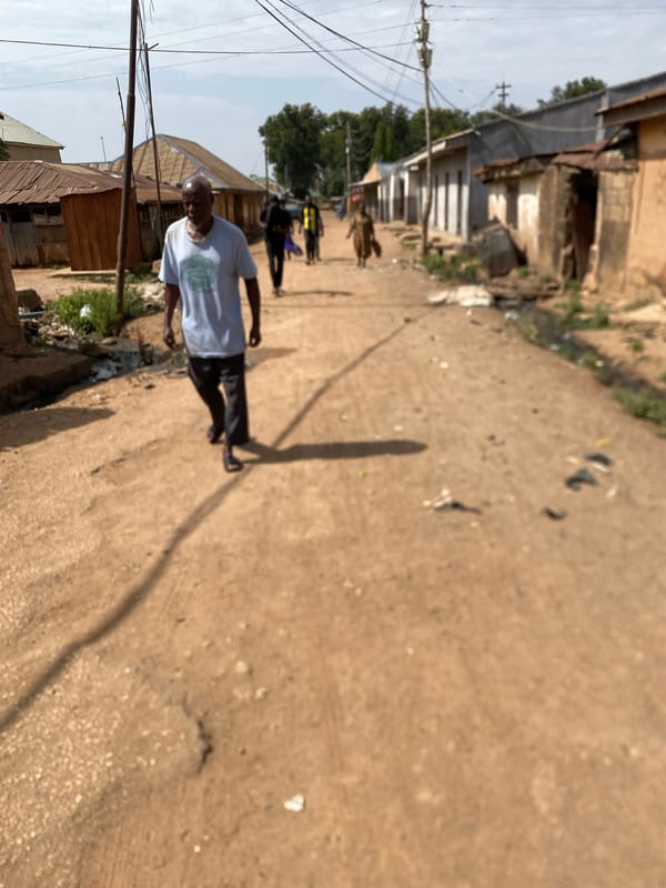 Daily life unfolds on Bukuru streets amid rickshaws, pedestrians