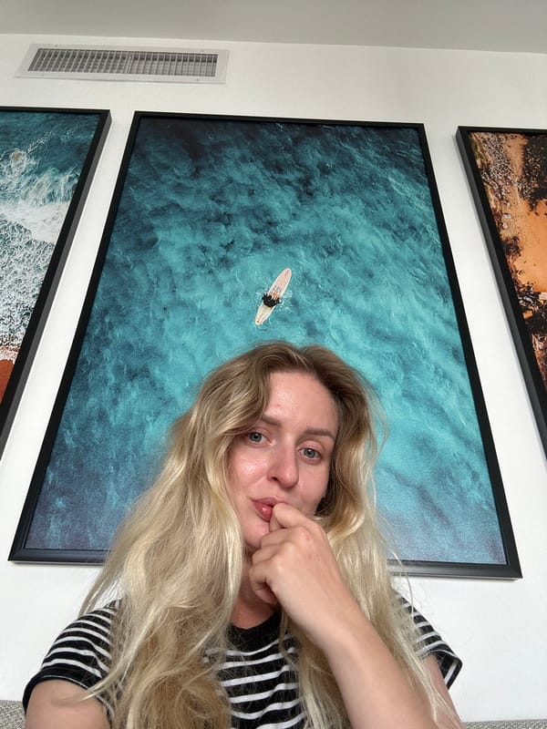 Woman photographed near artwork, skincare products in Petah Tikva