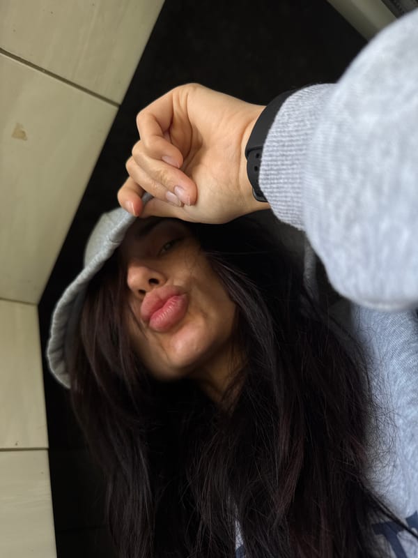 Woman in gray hoodie photographed on floor in Bulgaria