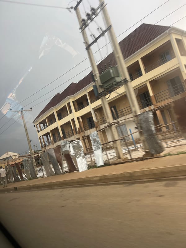 Yellow multi-story building mid-construction in Bukuru, Nigeria