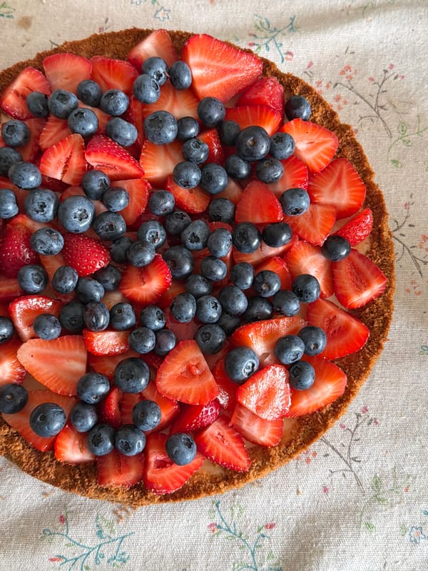 Strawberry and blueberry tart on a white tablecloth in Kazan