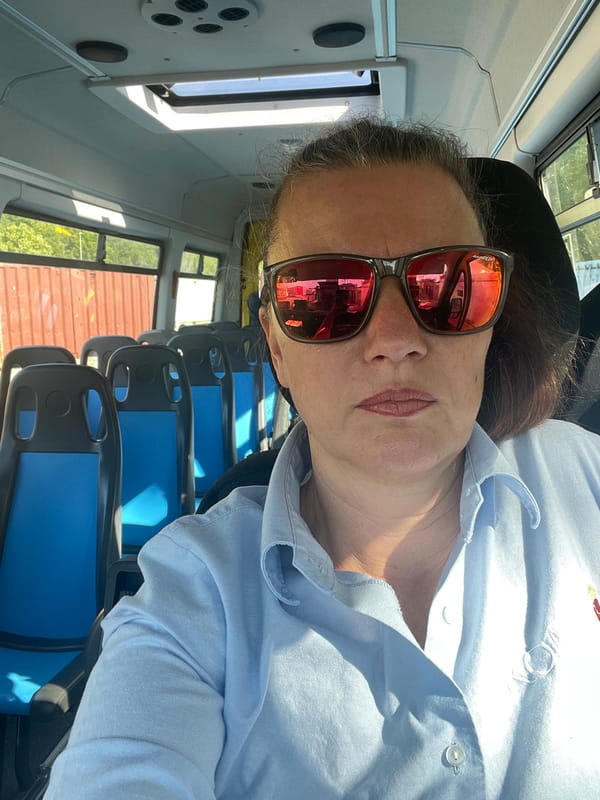 Woman in sunglasses rides morning bus in Rome