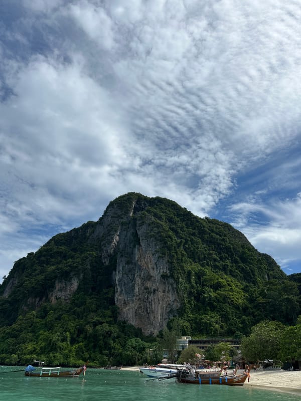 Tourists explore Ao Nang's limestone cliffs and beaches by boat