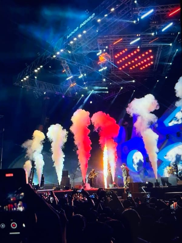 Live concert with pyrotechnics, crowds, and a Venezuela reference