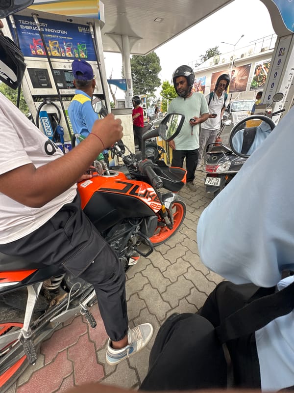 Urban motorcycle ride and fuel stop, likely India