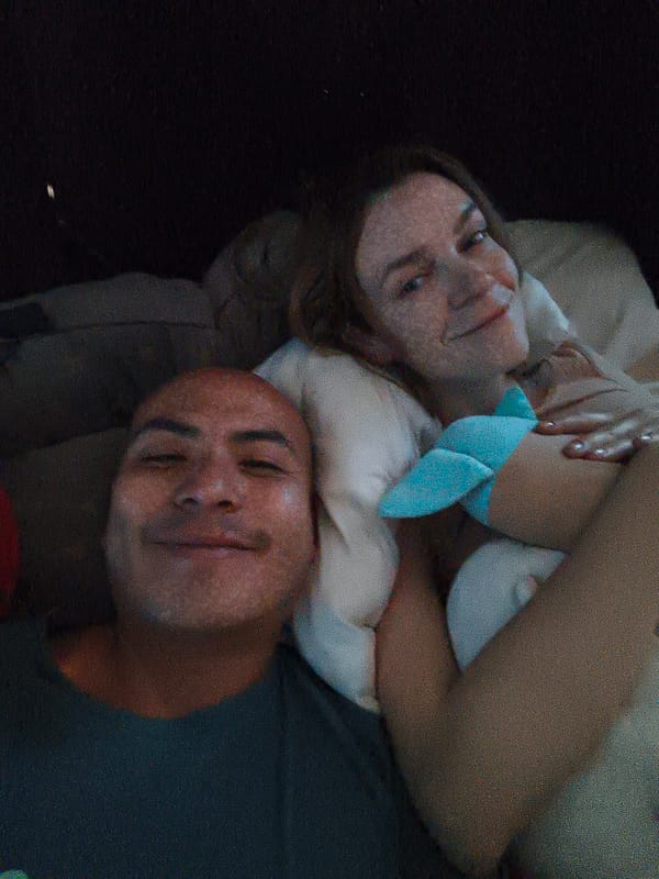 Two people photographed resting in bed in Mexico City