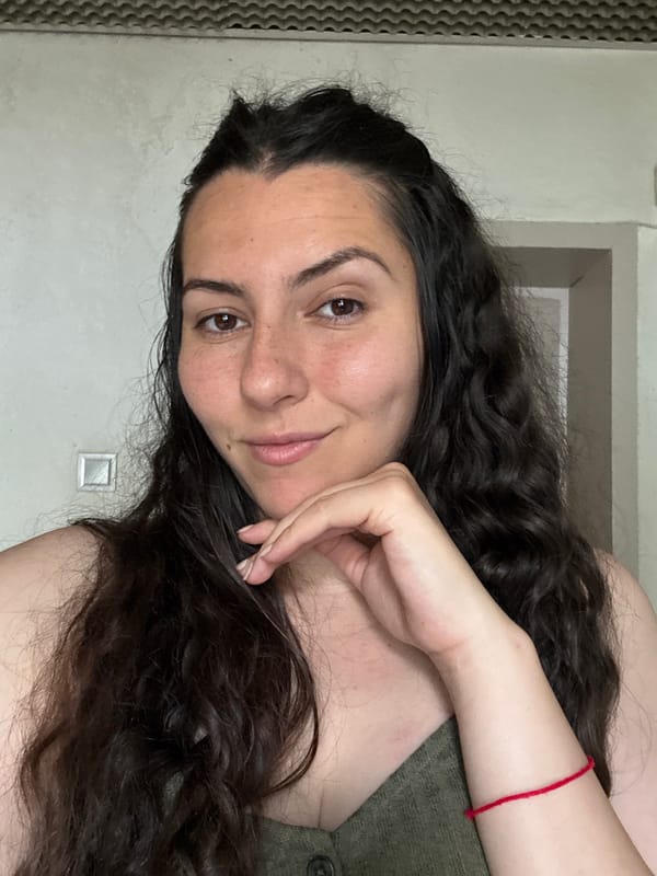 Relaxed portrait, green top and red string bracelet