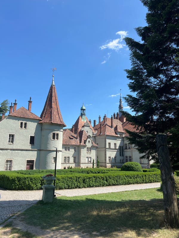 Ornate castle and lily pad pond on a sunny day in Karpaty