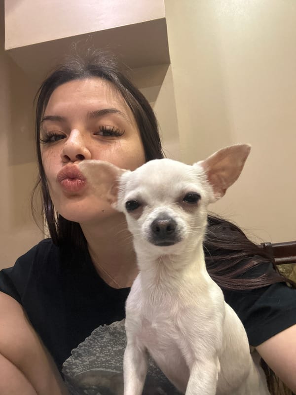 Woman poses with white dog in Sliven, Bulgaria
